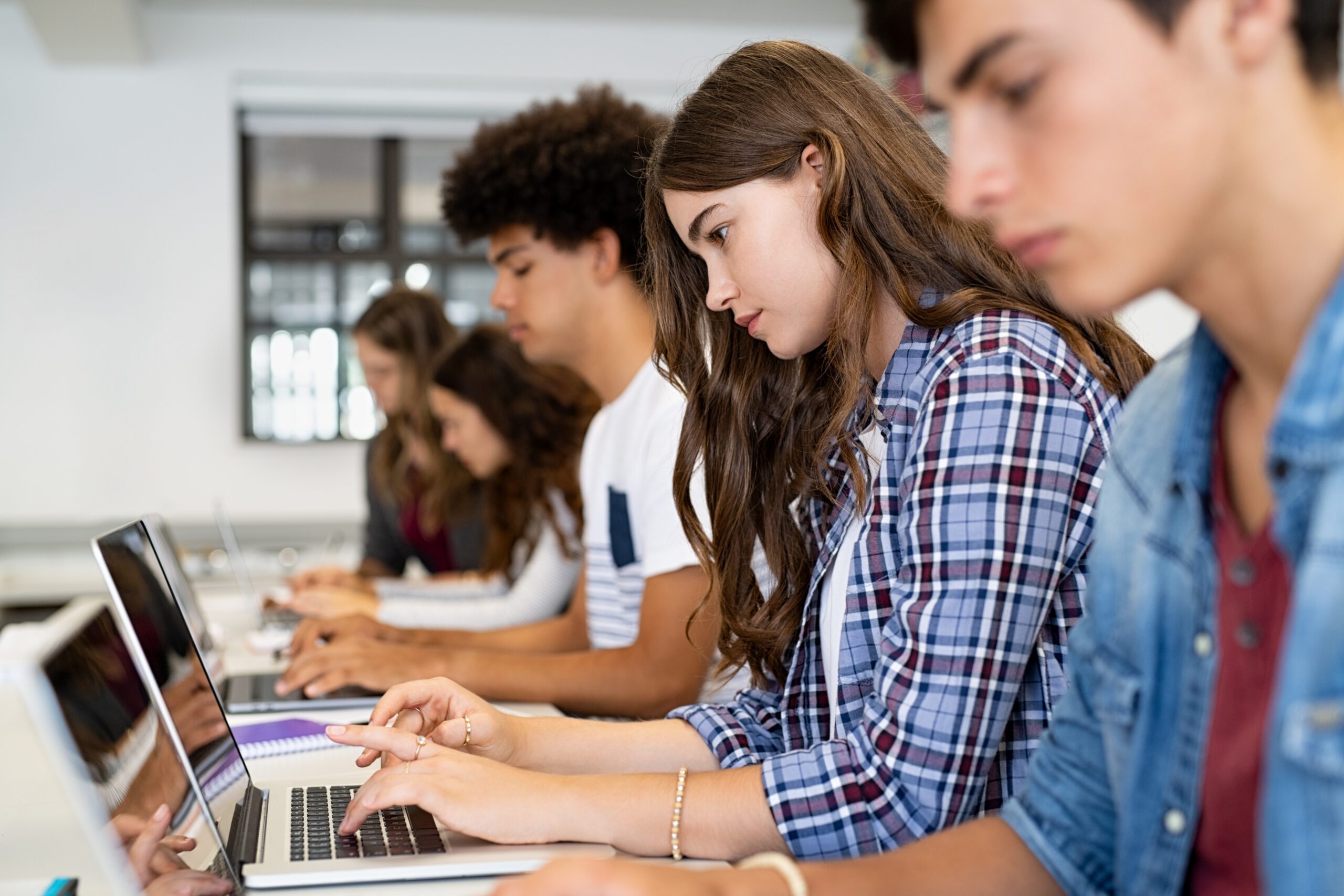 Students working together at desks during a high school class